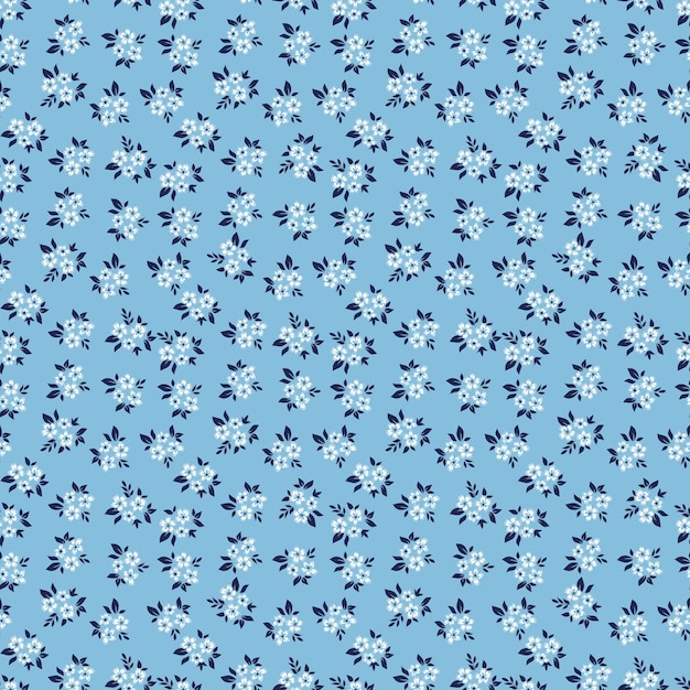 Fondo floral vintage Patrón floral con pequeñas flores blancas sobre un fondo azul