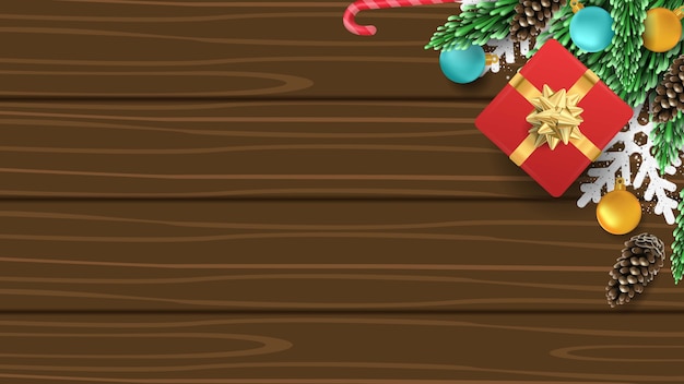 Vector fondo de navidad 3d con caja de regalo, pino, bola, caramelo y copo de nieve en madera