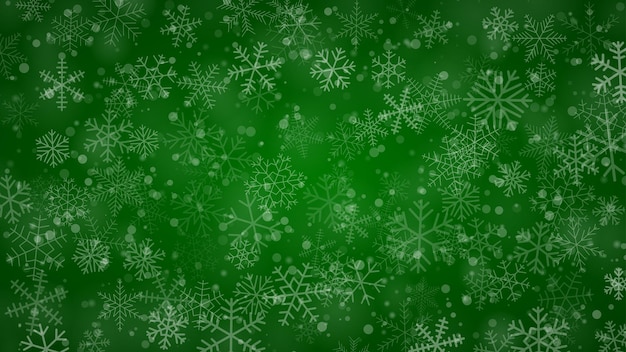 Fondo navideño de copos de nieve de diferentes formas, tamaños y transparencia en colores verdes