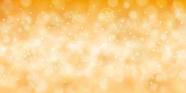 Fondo navideño de copos de nieve que caen complejos grandes y pequeños en colores amarillos con efecto bokeh
