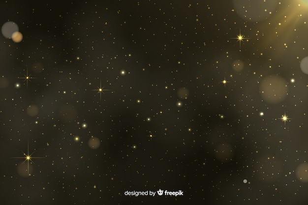 El fondo de partículas doradas de bokeh