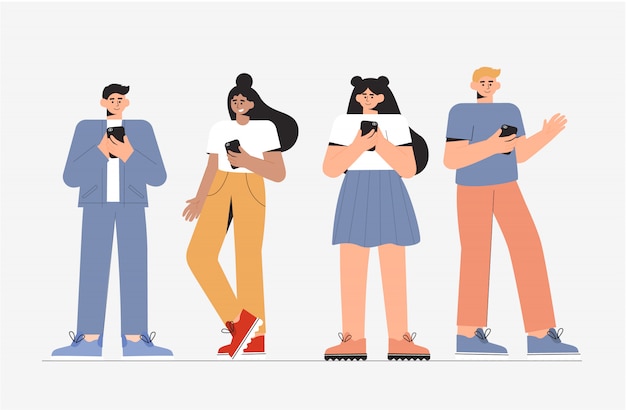 Grupo de jóvenes hombres y mujeres de pie y con teléfono.