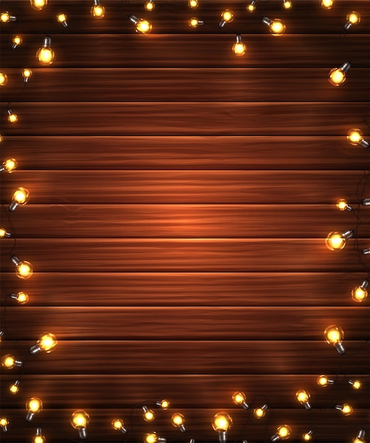 Guirnalda de luces de Navidad sobre fondo de madera
