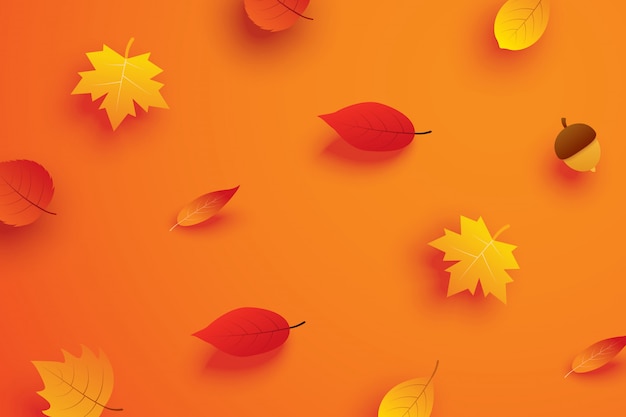Hojas de otoño en papel arte estilo fondo naranja.