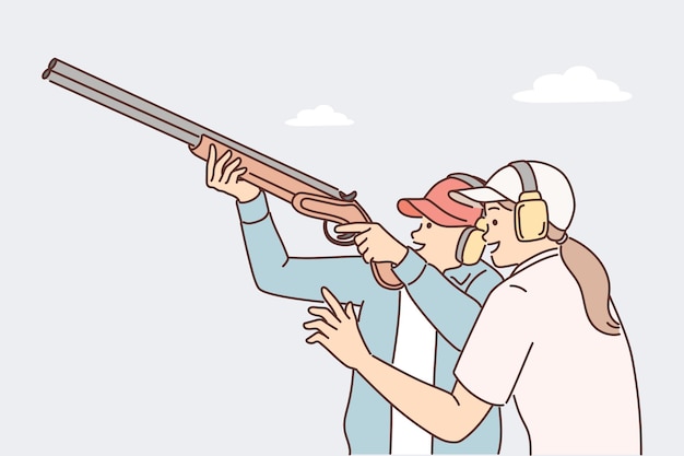 El hombre aprende a sostener el rifle y disparar címbalos con armas de fuego bajo la supervisión de una entrenadora