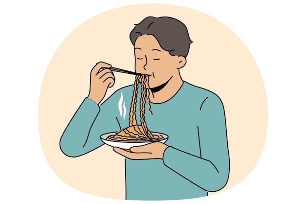 Un hombre asiático come ramen con palos chinos disfrutando del sabor de la comida nacional tradicional