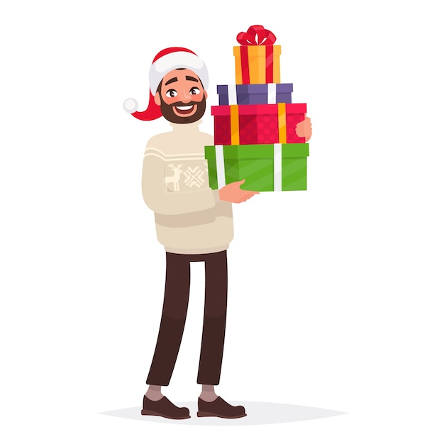 Hombre guapo vestido con un suéter y un sombrero de Navidad está sosteniendo regalos
