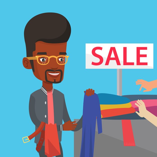 Hombre joven que elige la ropa en tienda en venta.