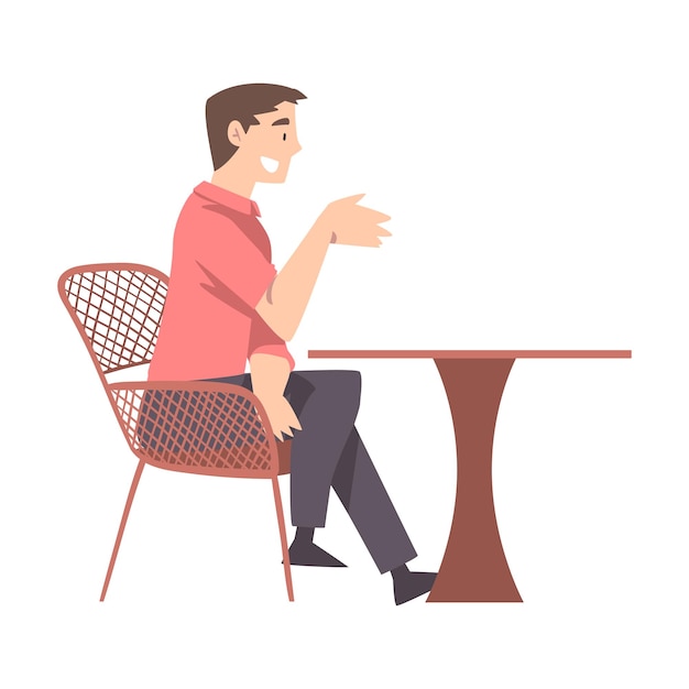 Vector hombre joven sentado en la mesa en un café bebiendo café y relajándose ilustración vectorial al estilo de dibujos animados