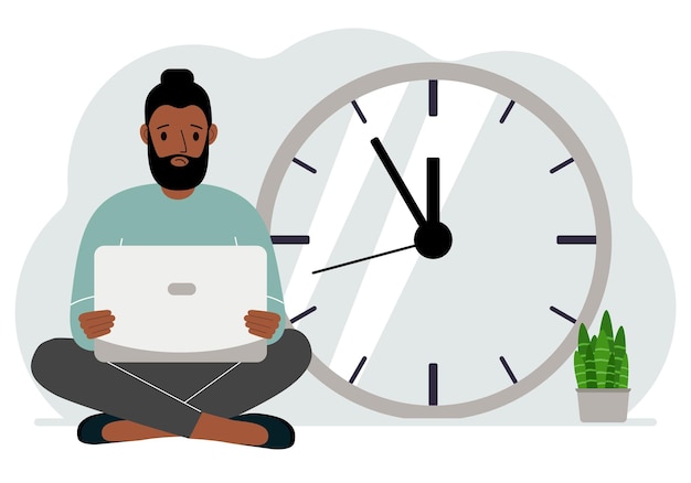 Un hombre se sienta con las piernas cruzadas y sostiene una computadora portátil junto al gran reloj Concepto de gestión del tiempo poco tiempo mucho tiempo límite