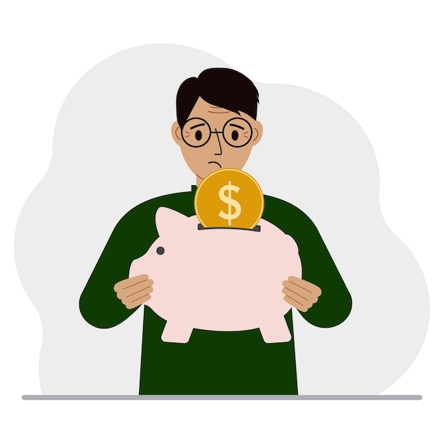El hombre triste sostiene una alcancía, una moneda cae en la alcancía El concepto de ahorro financiero ahorro inversión finanzas Vector ilustración plana