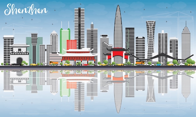 Horizonte de Shenzhen con edificios grises, cielo azul y reflexiones.