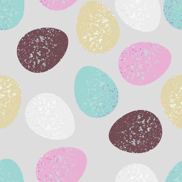 Los huevos de Pascua sobre un fondo gris hacen un patrón sin costuras