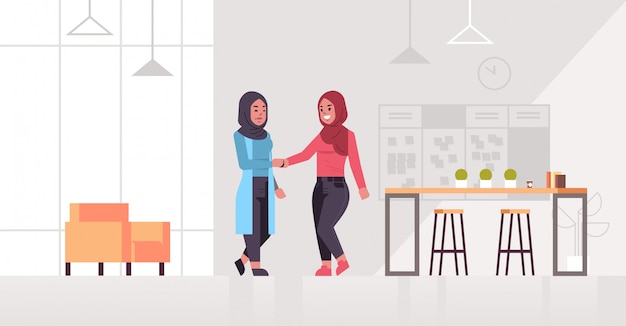 Ic mujeres empresarias apretón de manos árabe socios de negocios pareja apretón de manos durante la reunión acuerdo asociación concepto moderno centro de trabajo oficina interior horizontal horizontal