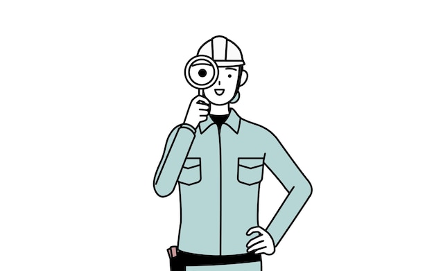 Ingeniera con casco y ropa de trabajo mirando a través de lentes de ampliación