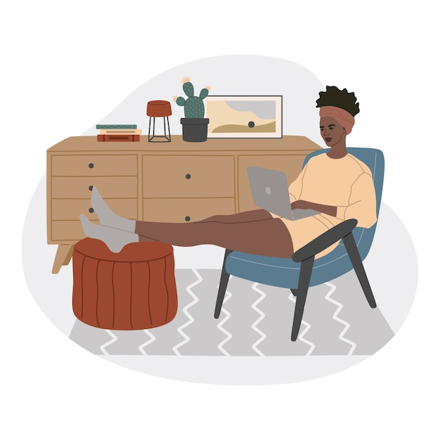 Joven afroamericana trabajando en casa en cuarentena en su computadora portátil