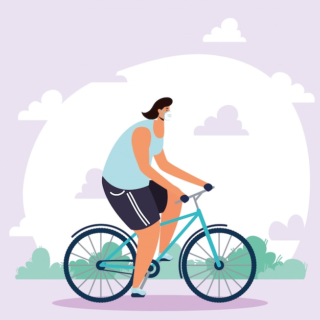 Joven con máscara médica en bicicleta