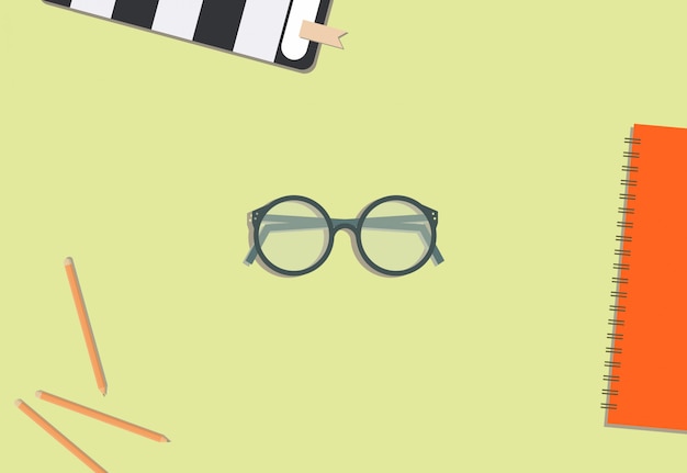 Vector lápiz de lentes y libro con fondo crema