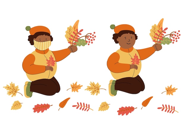 Lindo niño afroamericano con mascarilla protectora jugando con hojas de otoño