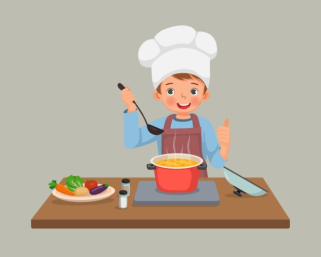 Lindo niño pequeño chef cocinando deliciosa sopa de verduras mostrando el pulgar hacia arriba