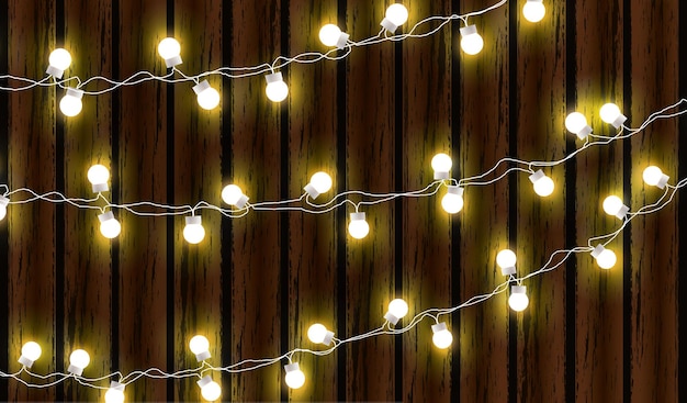 Vector luces de navidad aisladas sobre fondo de madera oscura guirnalda de resplandor bombillas de navidad de resplandor vectorial en cables