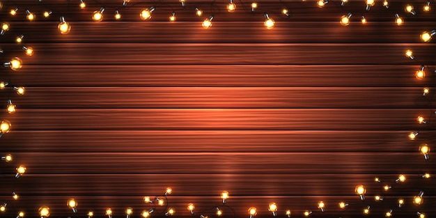 Luces de Navidad. Guirnaldas brillantes de Navidad de bombillas LED sobre fondo de textura de madera