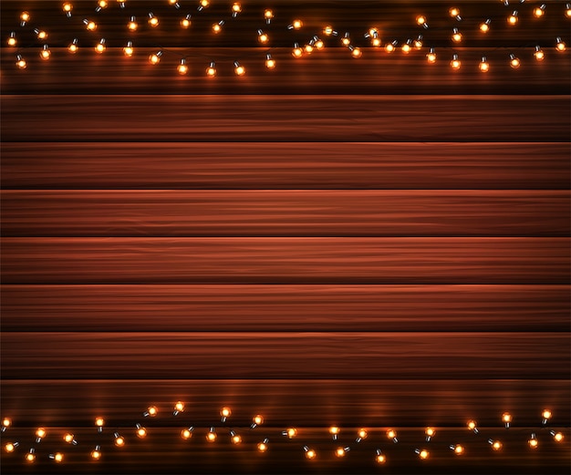 Luces de Navidad. Guirnaldas brillantes de Navidad de bombillas LED sobre fondo de textura de madera