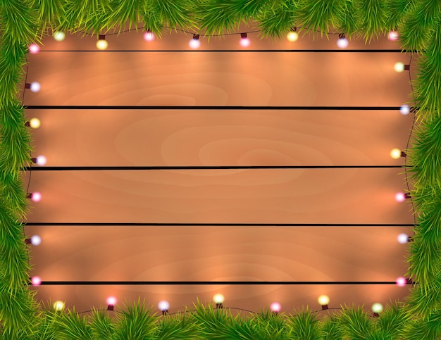 Luces de Navidad con ramas de abeto de fondo de madera