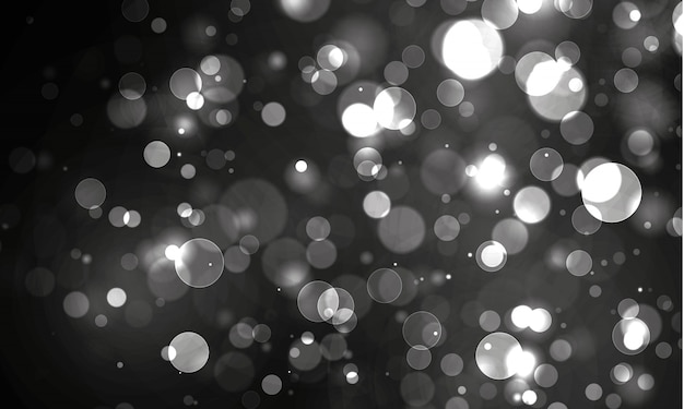 Luz bokeh borrosa sobre fondo negro. y plantilla de vacaciones de año nuevo. El brillo plateado abstracto desenfocaba estrellas y chispas parpadeantes.