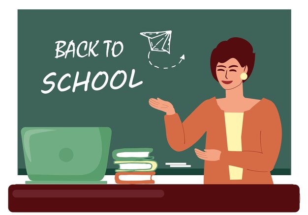 Una maestra está de pie en la pizarra de regreso a la escuela