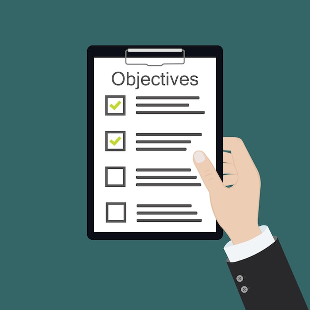 En la mano lista de verificación de objetivos del tablero de objetivos