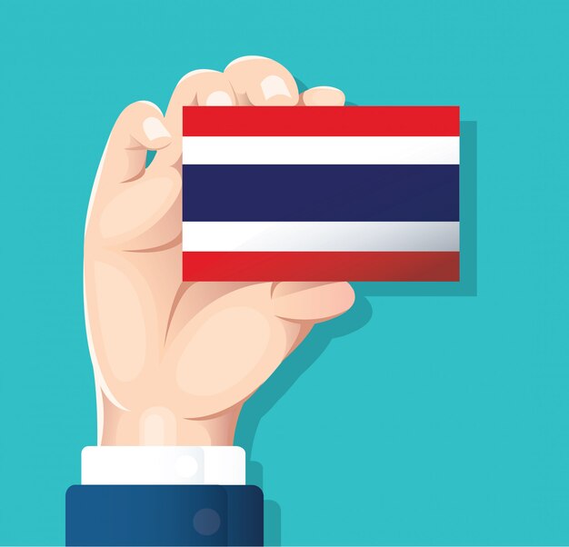 mano que sostiene la tarjeta de la bandera de Tailandia