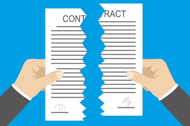 Manos que sostienen dos partes de un contrato roto