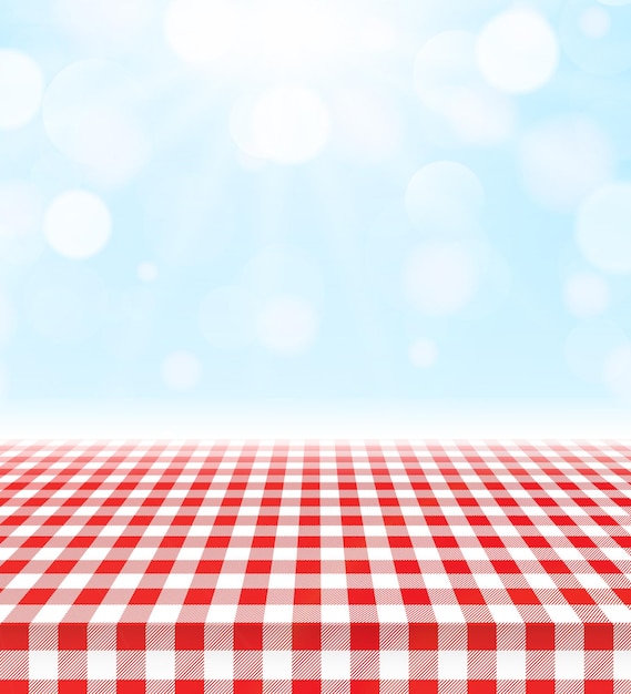 Un mantel de mesa a cuadros rojos sobre un fondo de picnic soleado