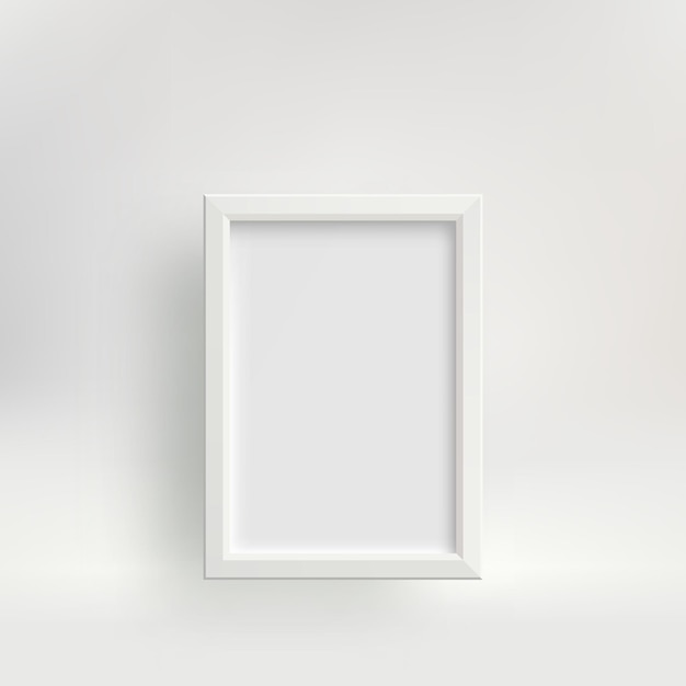 Marco de fotos vertical blanco con una sombra contra una pared clara