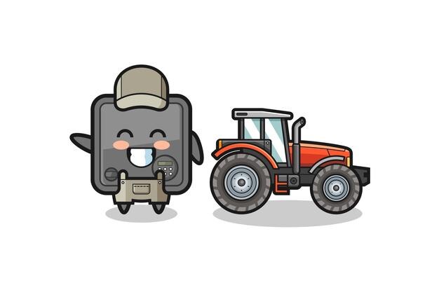 La mascota del granjero de la caja de seguridad parada al lado de un tractor