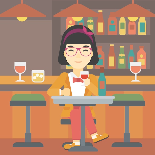 Mujer bebiendo vino en el restaurante.