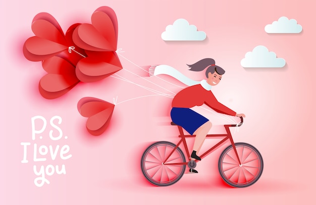 Mujer joven montando bicicleta y sosteniendo globos de corte de papel de corazón rojo. concepto de tarjeta romántica de amor. feliz día de san valentín