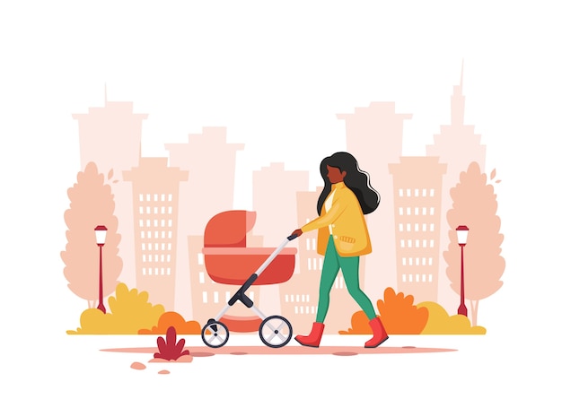 Mujer negra caminando con cochecito de bebé en otoño. Concepto de actividad al aire libre.