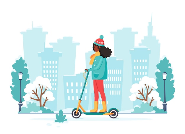 Mujer negra montando patinete eléctrico en invierno