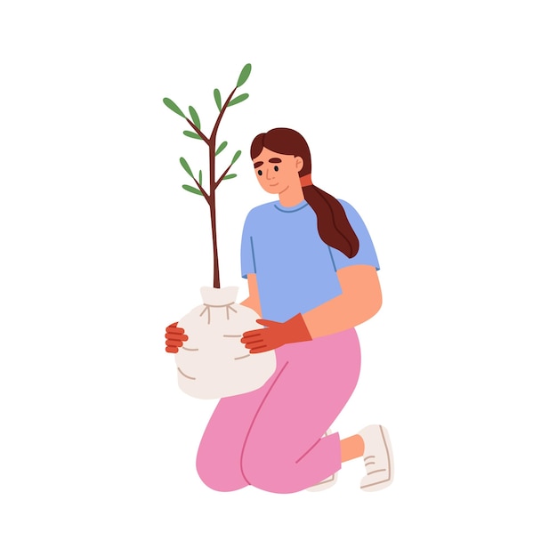 La mujer planta un árbol.