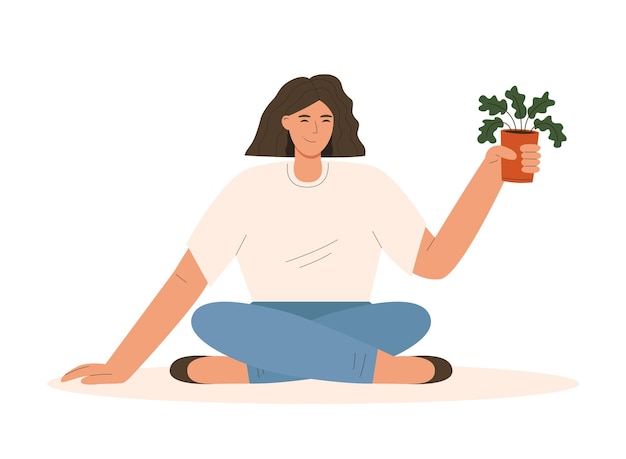 Mujer sentada y sosteniendo una planta en maceta Concepto de cultivo y cuidado de plantas de interior