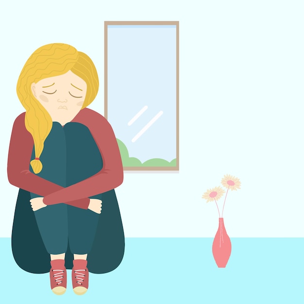 mujer sentada en el suelo cerca de la ventana