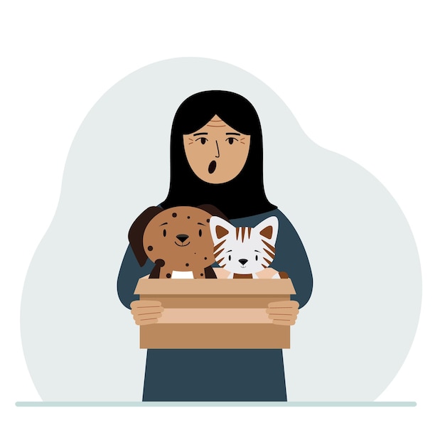 Una mujer sostiene una caja de cartón con un gato y un perro El concepto de ayuda de rescate y cuidado de mascotas