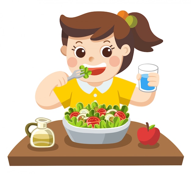 Una niña feliz de comer ensalada. A ella le encantan las verduras.
