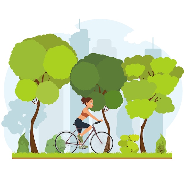 Niña montando una bicicleta por el parque de la ciudad.