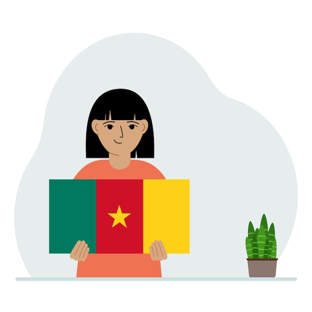 Una niña sostiene la bandera de Camerún en sus manos El concepto de fiesta nacional de demostración o patriotismo Nacionalidad