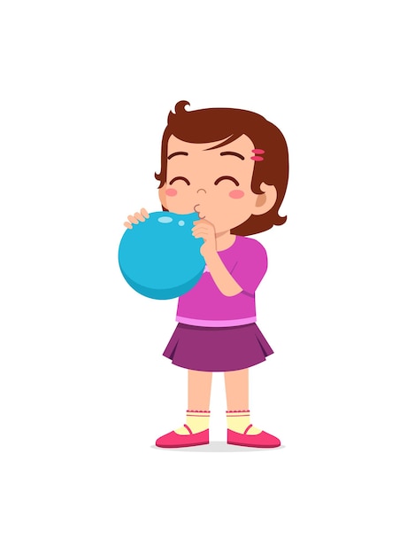 Un niño pequeño de pie y soplando un globo