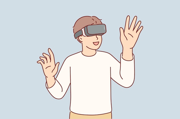 Un niño que usa gafas VR utiliza con entusiasmo nueva tecnología para sumergirse en la realidad virtual con efecto 3D. Un niño asombrado juega un juego VR y levanta las manos para tocar objetos invisibles.