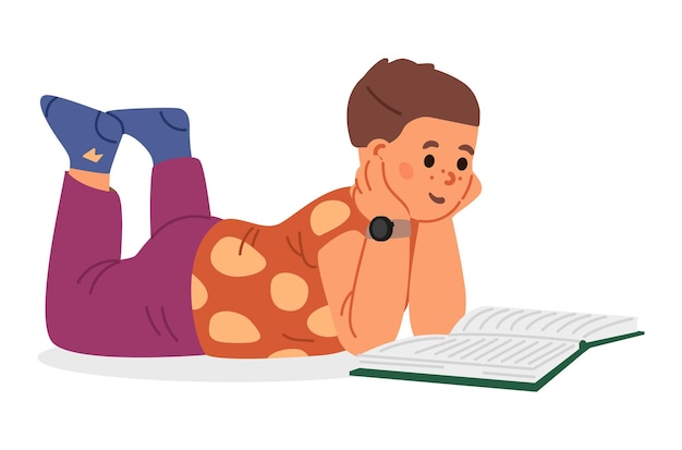 Niño tendido en el suelo leyendo un libro